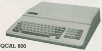 Wedge-shaped retro computer console with an integrated beige QWERTY keyboard, integrated numeric keypad, and distinct functional control button layouts.